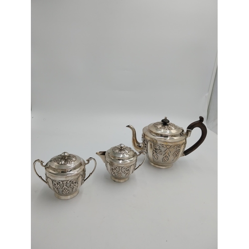 1367 - Three piece Indian silver tea service decorated with floral and foliage, the hinged teapot lid with ... 