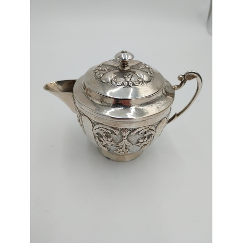 1367 - Three piece Indian silver tea service decorated with floral and foliage, the hinged teapot lid with ... 