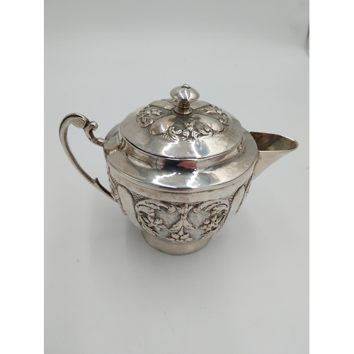 1367 - Three piece Indian silver tea service decorated with floral and foliage, the hinged teapot lid with ... 