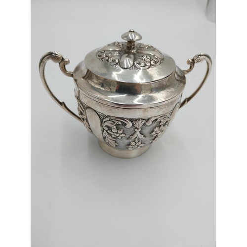 1367 - Three piece Indian silver tea service decorated with floral and foliage, the hinged teapot lid with ... 