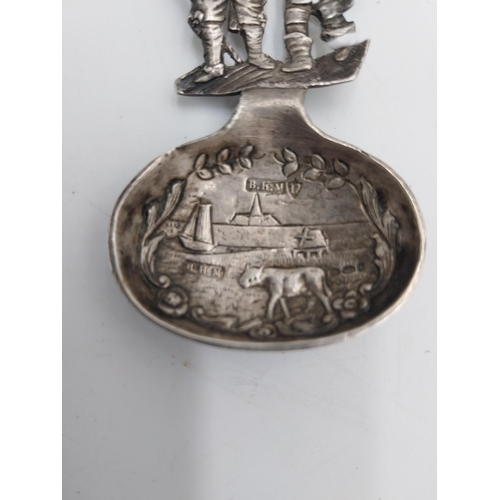 1369 - German silver tea caddy spoon , the bowl decorated with village scene with an oxen in the fore groun... 