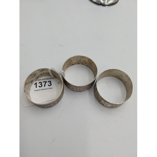 1373 - Three English silver napkin rings. Hallmarked in Birmingham 1902. Makers mark unclear Wt: 54grs. { 2... 