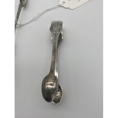 1386 - Two English silver sugar tongs. Hallmarked in London 1832 & Sheffield 1909. Wt: 90grs. { 15cm L & 11... 