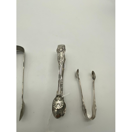 1386 - Two English silver sugar tongs. Hallmarked in London 1832 & Sheffield 1909. Wt: 90grs. { 15cm L & 11... 