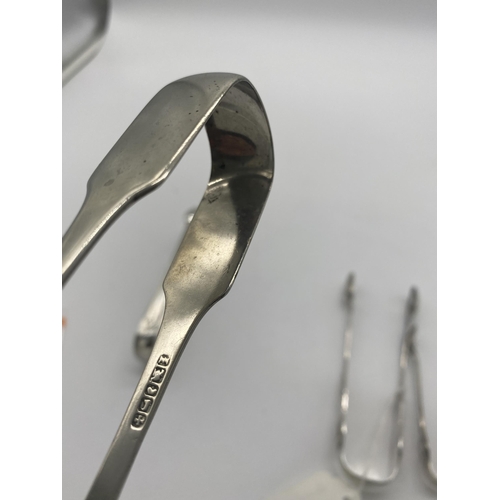 1386 - Two English silver sugar tongs. Hallmarked in London 1832 & Sheffield 1909. Wt: 90grs. { 15cm L & 11... 