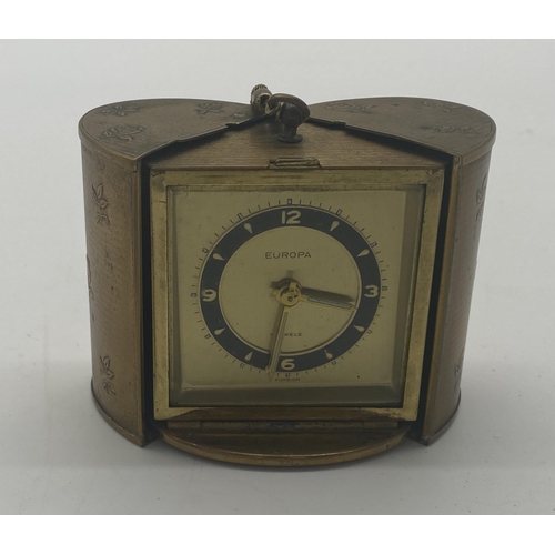 1422 - Europa travel clock in brass case. { 7cm H X 6cm W X 4cm D }.