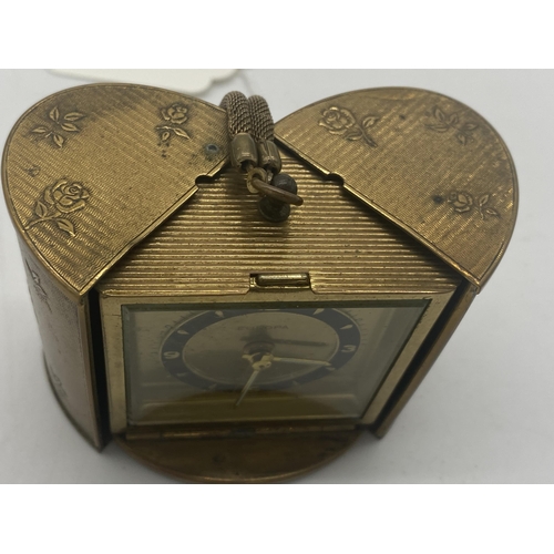 1422 - Europa travel clock in brass case. { 7cm H X 6cm W X 4cm D }.