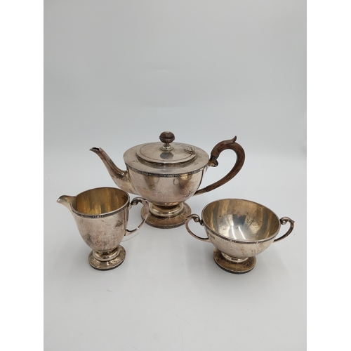 1430 - English silver three piece tea service, teapot with hinged cover, wooden finial and  handle, twin ha... 