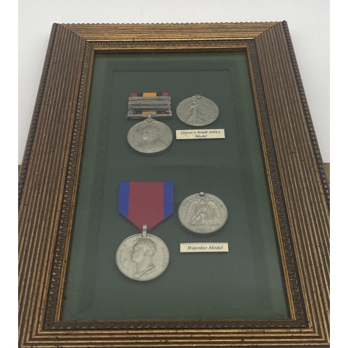 1431 - Set of replica Waterloo & Queen's South Africa medals with ribbons mounted in a glazed case.