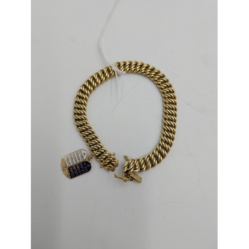 1482 - 14 carat gold rope chain bracelet { stamped 585 } with enamelled charm in the form of the Torah stam... 