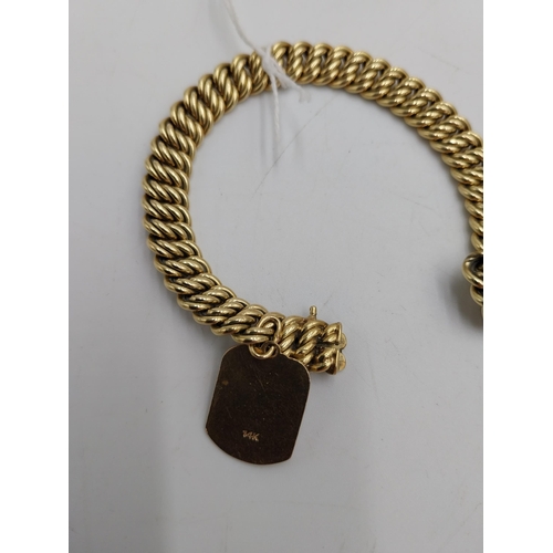 1482 - 14 carat gold rope chain bracelet { stamped 585 } with enamelled charm in the form of the Torah stam... 