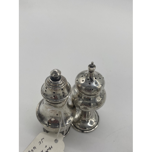 1401 - Pair of English silver salt & pepper pots, the cartouche monogrammed MD. Hallmarked in Birmingham 19... 