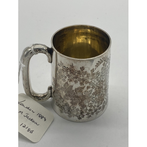 1408 - English silver mug decorated with foliage. Hallmarked in London 1884. Maker George Maudsley Jackson.... 