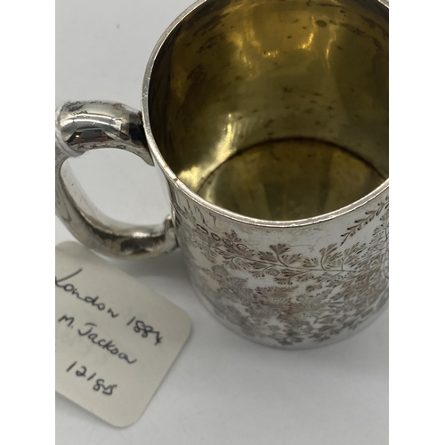 1408 - English silver mug decorated with foliage. Hallmarked in London 1884. Maker George Maudsley Jackson.... 