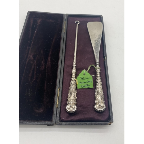 1412 - Sterling silver handled shoe horn and button hook in original presentation case. { Both 17cm L }.