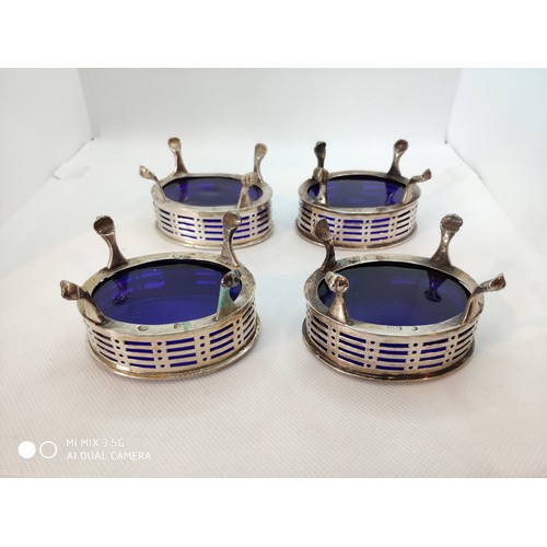 1395 - Set of four Irish Georgian silver salts with Bristol blue liners, the frames of oval form with pierc... 