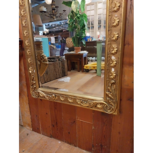 109 - Decorative gilt wall mirror in the Victorian style {115 cm H x 64 cm W}.