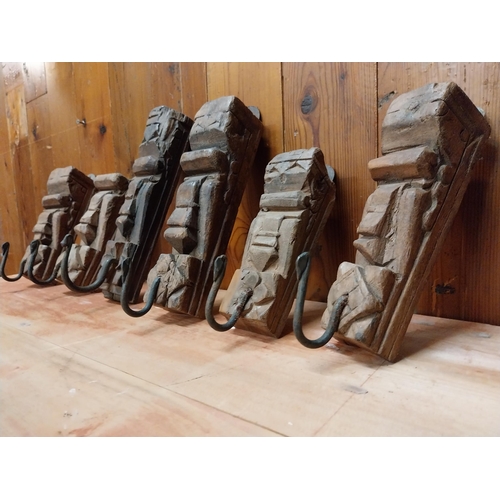 121 - Collection of six carved hardwood wall mounted coat hangers {Approx. 20  cm H x 8 cm W x 9 cm D}.