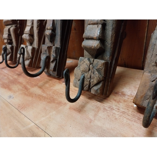 121 - Collection of six carved hardwood wall mounted coat hangers {Approx. 20  cm H x 8 cm W x 9 cm D}.