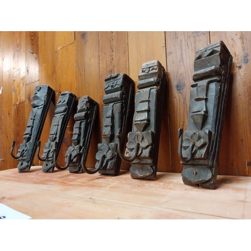 122 - Collection of six carved hardwood wall mounted coat hangers {Approx. 28 cm H x 8 cm W x 10 cm D}.