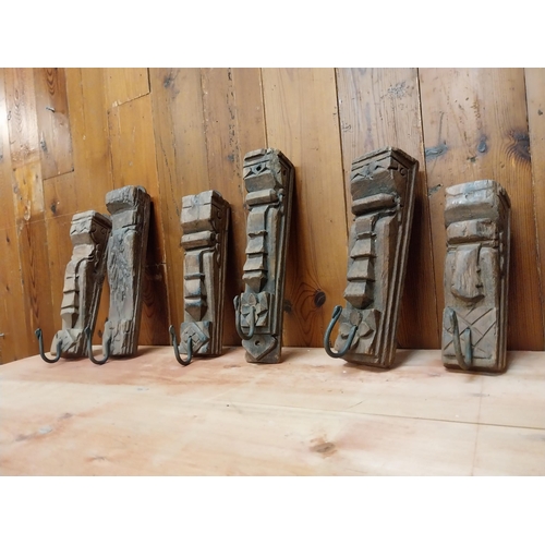 123 - Collection of six carved hardwood wall mounted coat hangers {Approx. 29 cm H x 8 cm W x 10 cm D}.