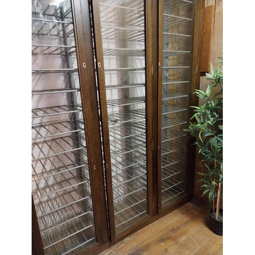 145 - Large wooden and metal wine cabinet with four glazed doors {256 cm H x 256 cm W x 49 cm D}.