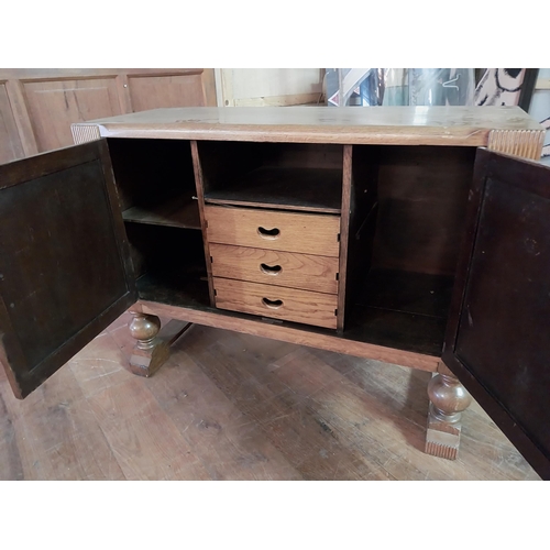 153 - Art Deco oak side board with two panelled doors and fitted interior raised on turned legs {90 cm H x... 