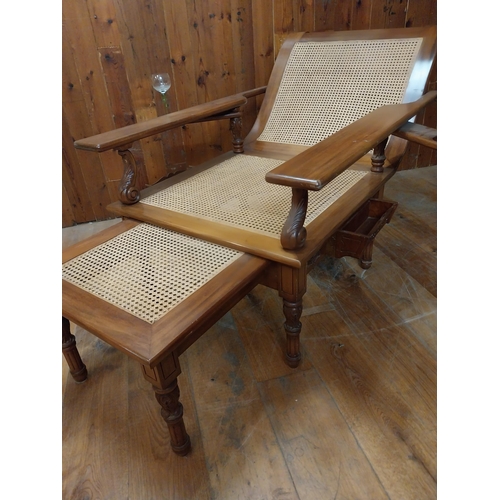 161 - Unusual large mahogany and bergere plantation chair raised on turned legs {91 cm H x 184 cm W x 100 ... 