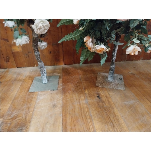 253 - Three artificial flowers mounted on metal stands {96 cm H x 47 cm Dia. And 90 cm H x 57 cm Dia.}.