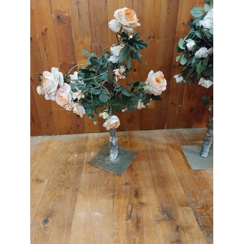 253 - Three artificial flowers mounted on metal stands {96 cm H x 47 cm Dia. And 90 cm H x 57 cm Dia.}.