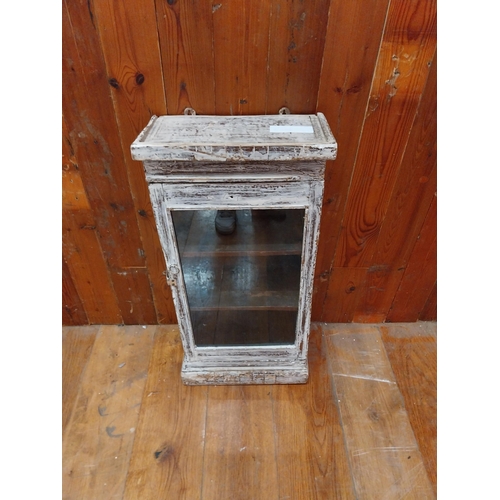 297 - Painted hardwood wall cabinet with single glazed door {77 cm H x 38 cm W x 21 cm D}.