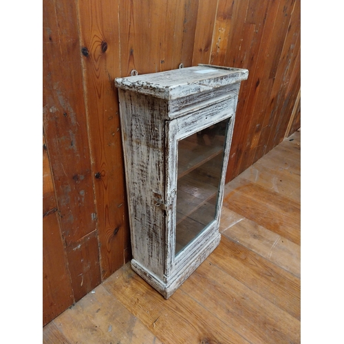 297 - Painted hardwood wall cabinet with single glazed door {77 cm H x 38 cm W x 21 cm D}.