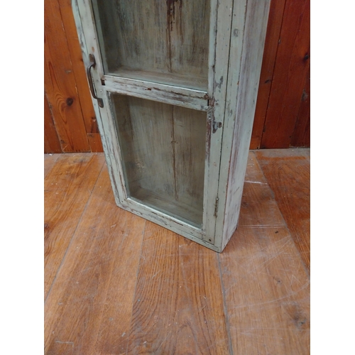 299 - Painted hardwood wall cabinet with single glazed door {77 cm H x 36 cm W x 11 cm D}.