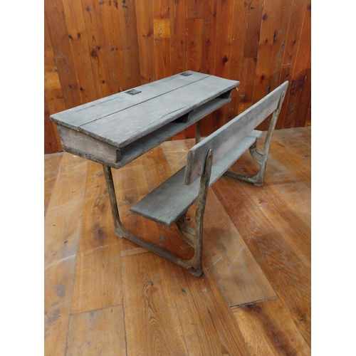 381 - 1950s oak and cast iron double school desk {63 cm H x 102 cm W x 63 cm D}.