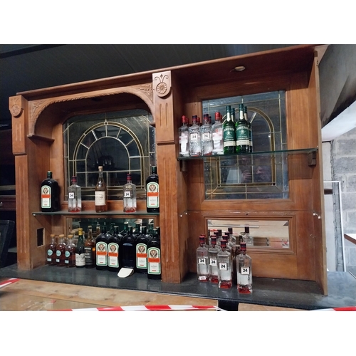 403 - Stained pine bar back with coloured glass inset panels {140 cm H x 250 cm W x 30 cm D}.