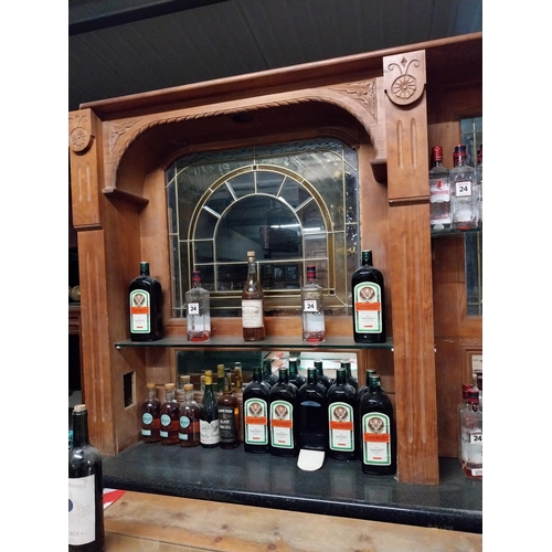 403 - Stained pine bar back with coloured glass inset panels {140 cm H x 250 cm W x 30 cm D}.