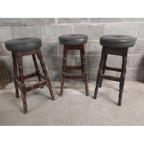 440 - Three stained pine bar - pub  stools with upholstered seats {79 cm H x 40 cm W x 40 cm D}.