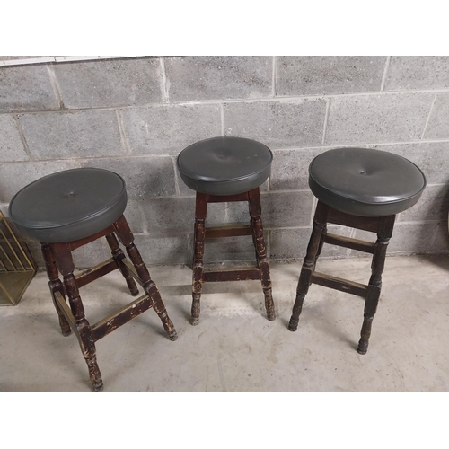 440 - Three stained pine bar - pub  stools with upholstered seats {79 cm H x 40 cm W x 40 cm D}.