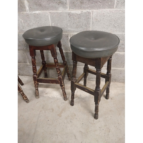 440 - Three stained pine bar - pub  stools with upholstered seats {79 cm H x 40 cm W x 40 cm D}.