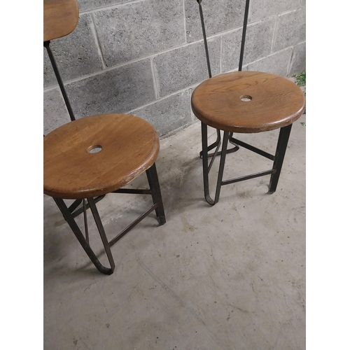 459 - Pair of bar - pub chairs with oak seats on wrought iron bases {86 cm H x 40 cm W x 43 cm D}.