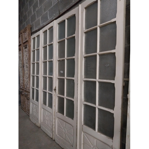 514 - Pair of 19th C. painted pine doors with glazed panels above two blind panels flanked by two side pan... 