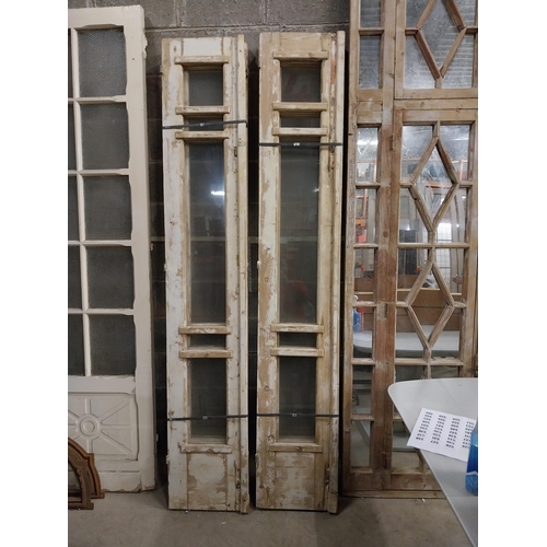 526 - Four good quality painted pine window shutters with glazed panels {142 cm H x 42 cm W x 7 cm D}.