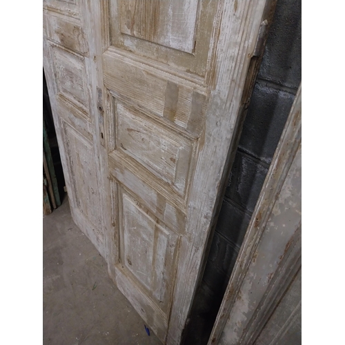 561 - Pair of 19th C. distressed pine panelled doors {240 cm H x 50 cm W x 6 cm D}.