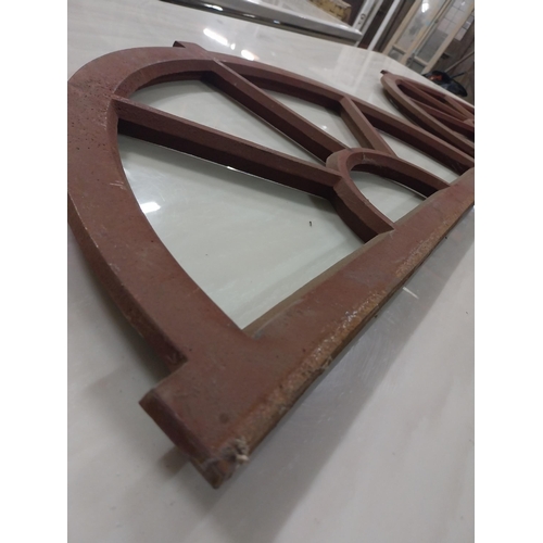 569 - Pair of good quality arched cast iron window frames {37 cm H x 67 cm W x 3 cm D}.