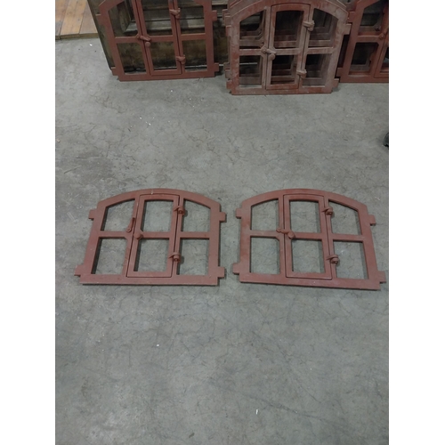 580 - Pair of good quality cast iron window frames with single door {42 cm H x 55 cm W x 4 cm D}.