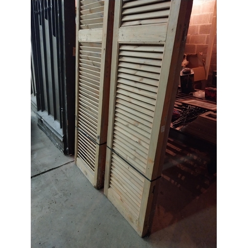 600 - Set of four distressed pine Louvre window shutters{254 cm H x 49 cm W x 5 cm D}.