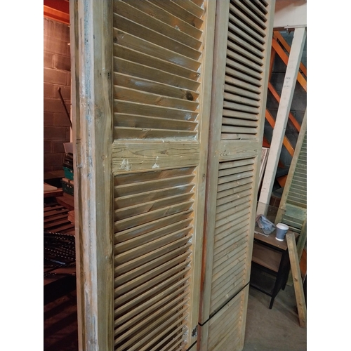 600 - Set of four distressed pine Louvre window shutters{254 cm H x 49 cm W x 5 cm D}.