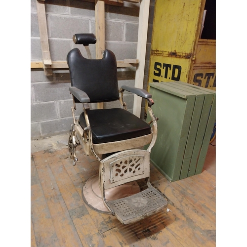 617 - Early 20th C. cast iron and upholstered vinyl barbers chair{115 cm H x 60 cm W x 100 cm D}.