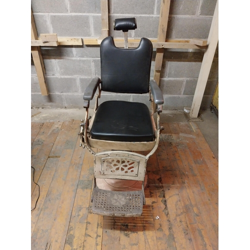 617 - Early 20th C. cast iron and upholstered vinyl barbers chair{115 cm H x 60 cm W x 100 cm D}.