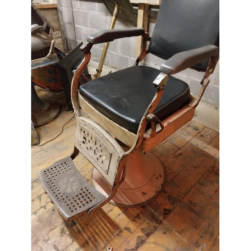 617 - Early 20th C. cast iron and upholstered vinyl barbers chair{115 cm H x 60 cm W x 100 cm D}.